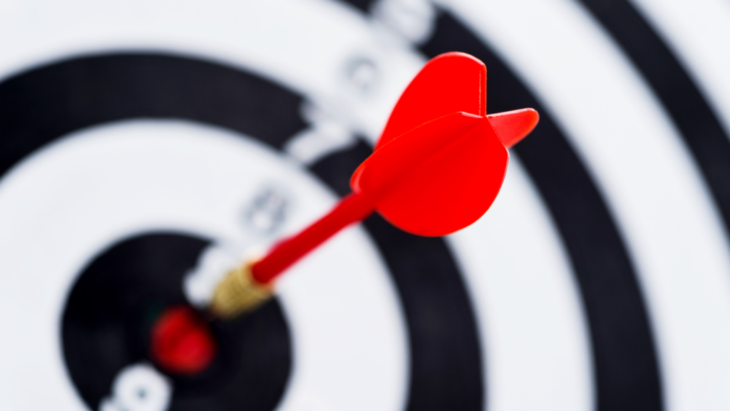 An image showing darts hitting the bullseye of a target illustrating the idea of successfully reaching and engaging the intended audience through targeted marketing strategies.
