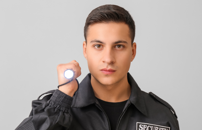 An Image of A Night Watchman With A Light Up Stun Gun in Hand