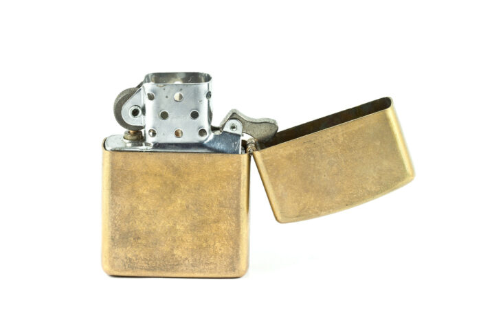 an image of a gold lighter on a white background