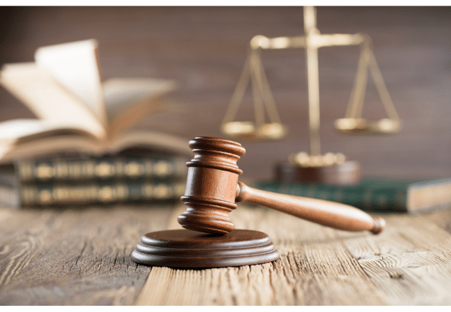 a gavel, justice scale and law books
