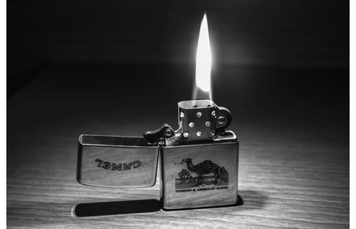 a pocket lighter on a table black and white image