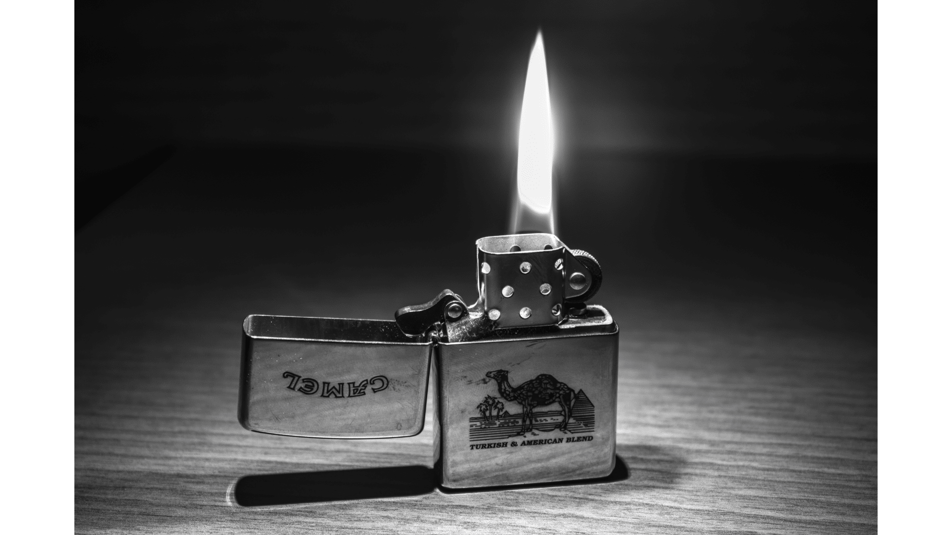 a pocket lighter on a table black and white image