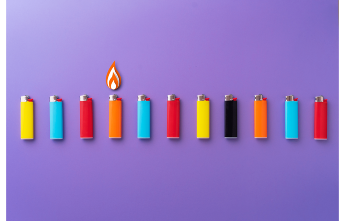 set of colorful bulk lighters on a purple surface.